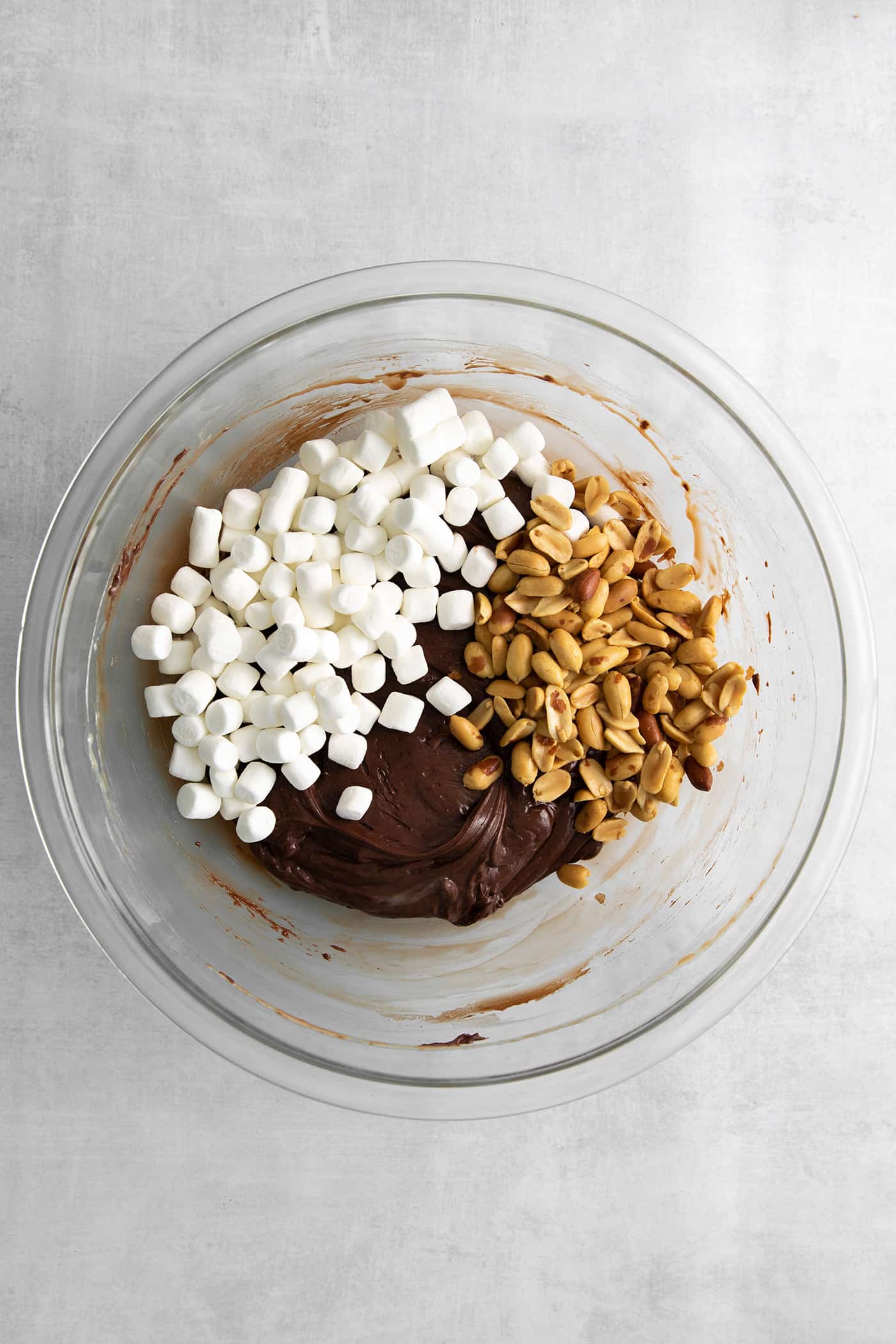 Marshmallows, peanuts, and melted chocolate in a bowl