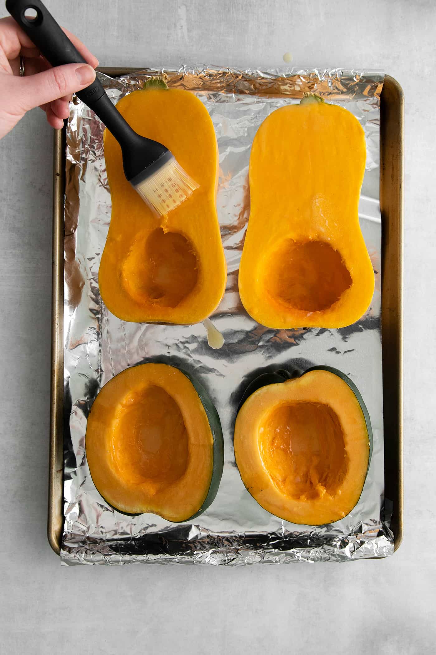 Cut squash being brushed with melted butter
