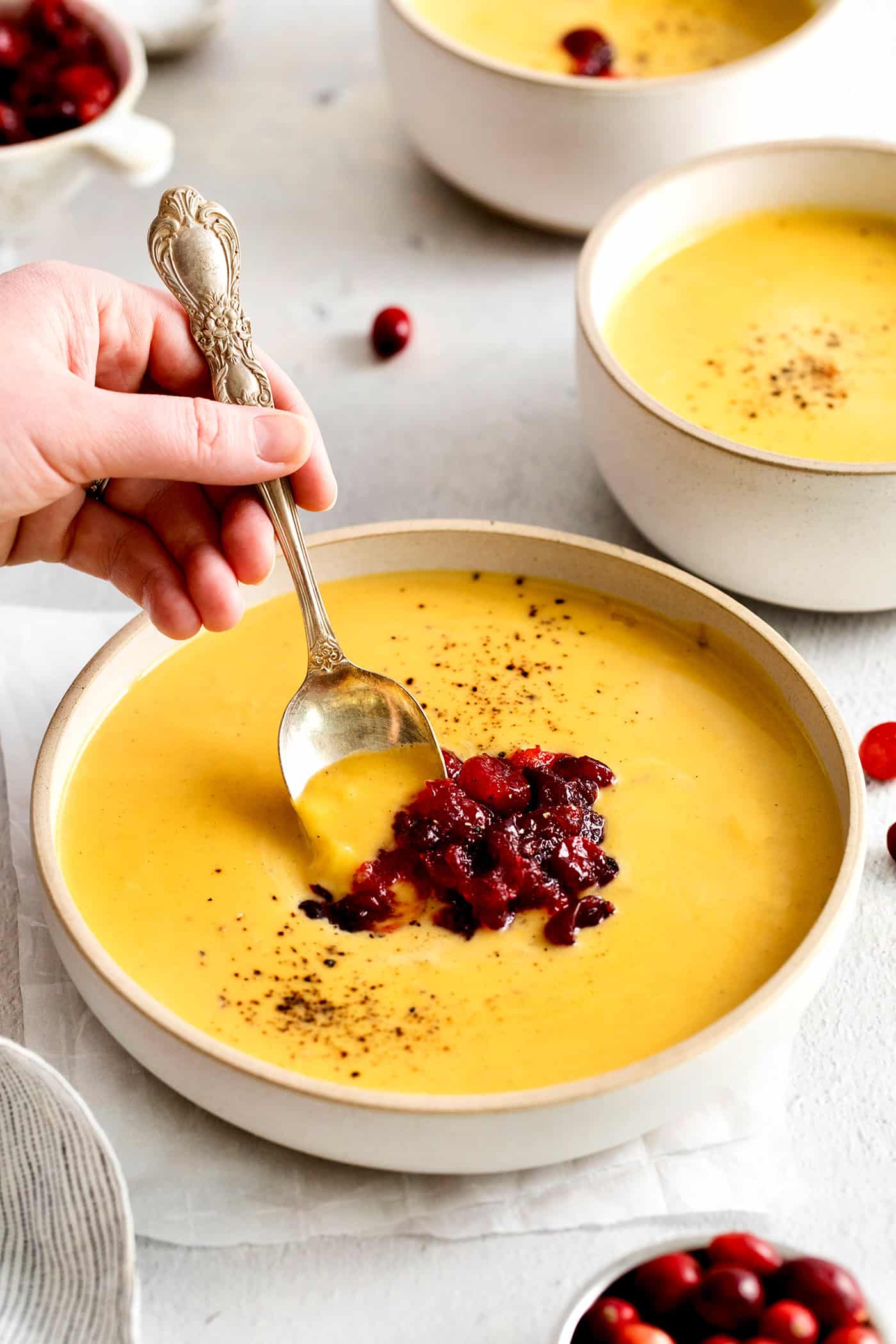 A spoon in a bowl of squash soup