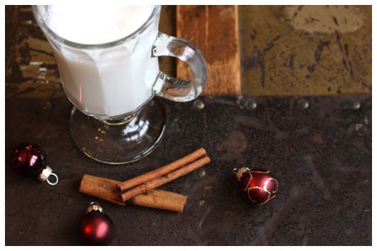 a glass of steamer with cinnamon sticks