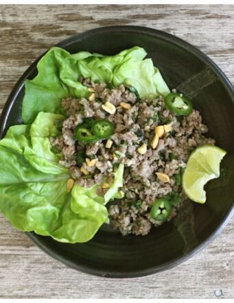 a pottery bowl of lettuce and ground pork