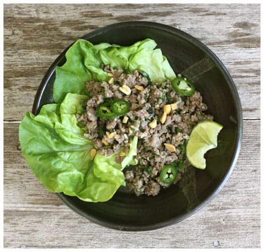 a pottery bowl of lettuce and ground pork