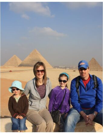 a family photo in front of the pyramids in egypt