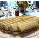 A glass plate of lefse pastries on a table