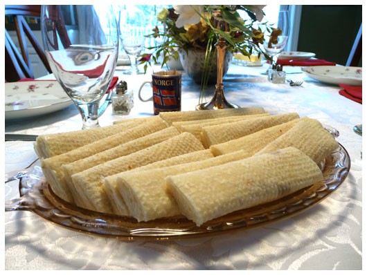 A glass plate of lefse pastries on a table