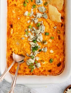 Overhead view of baked buffalo chicken dip with a spoon in it