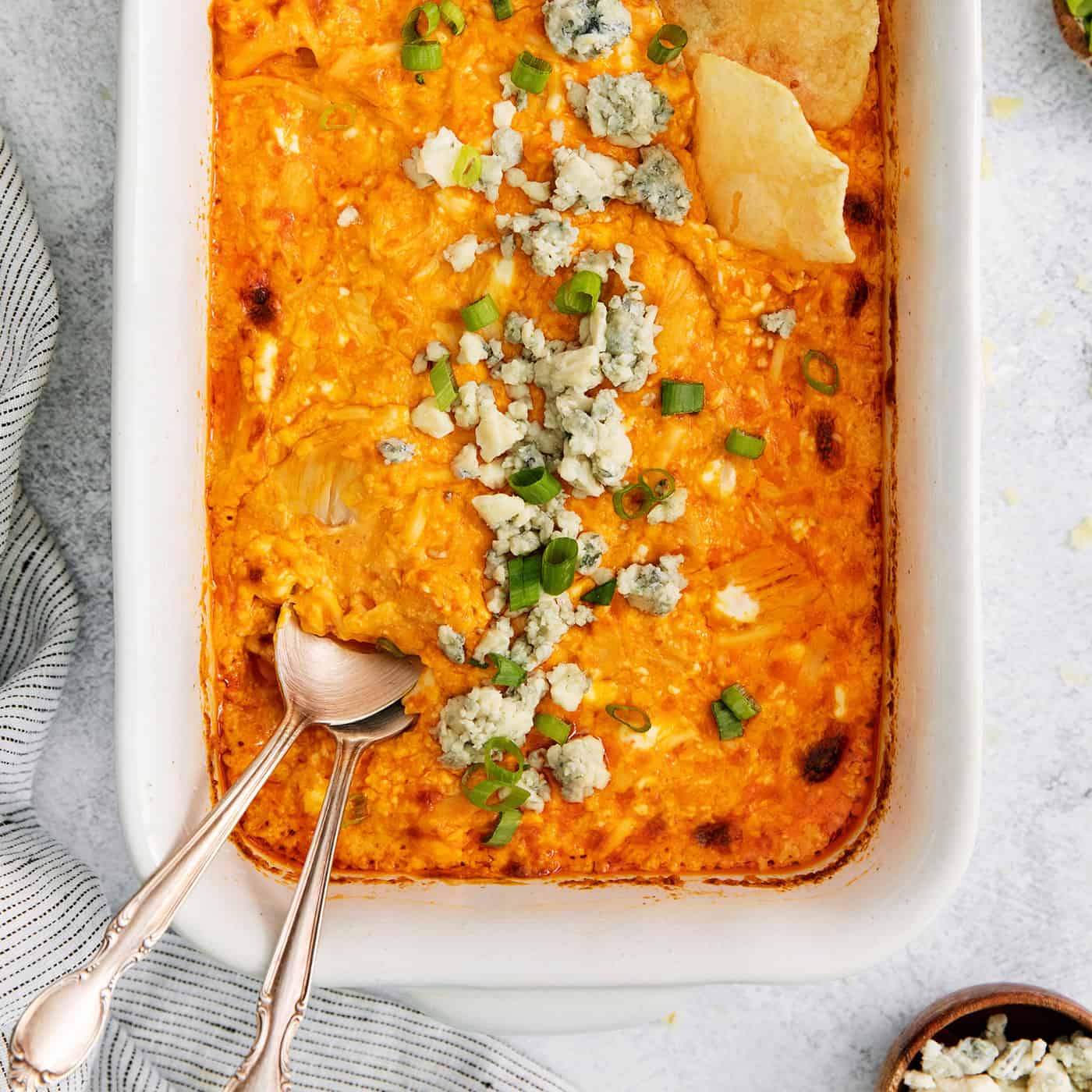 Overhead view of baked buffalo chicken dip with a spoon in it