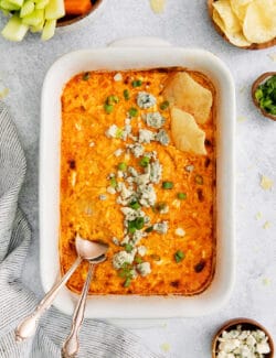 Overhead view of baked buffalo chicken dip with a spoon in it