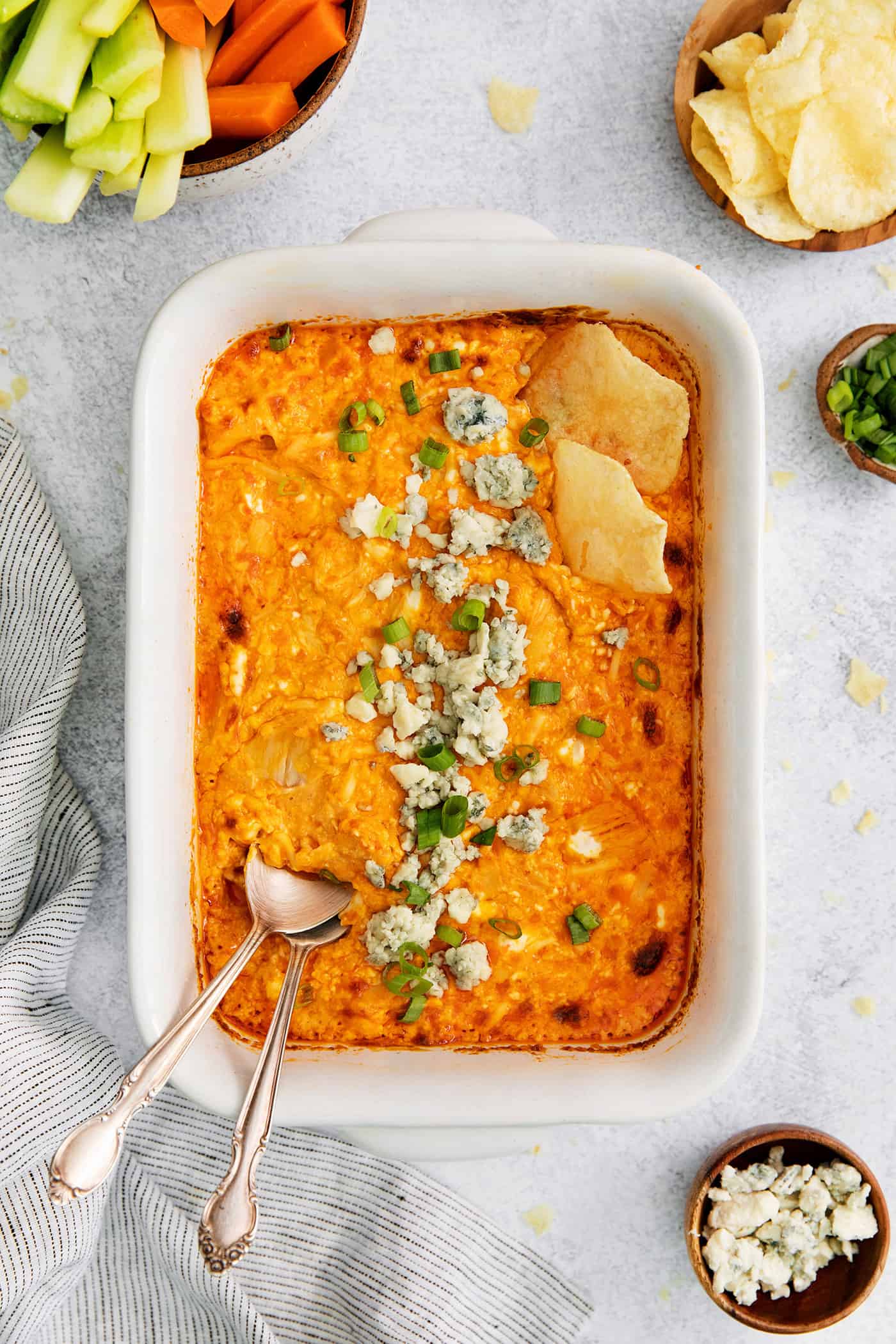 Overhead view of baked buffalo chicken dip with a spoon in it