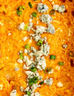 Close-up of buffalo chicken dip topped with blue cheese crumbles