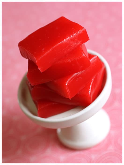 a stack of red cinnamon caramels