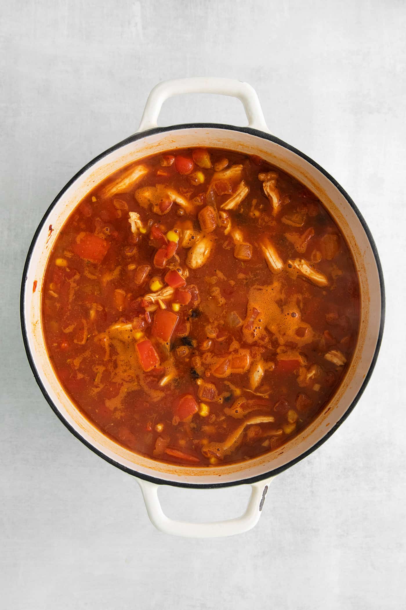 Overhead view of chicken tortilla soup in a pot