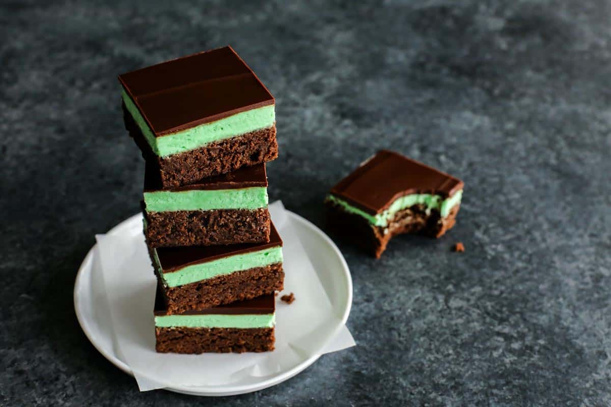 mint brownies stacked on a white plate