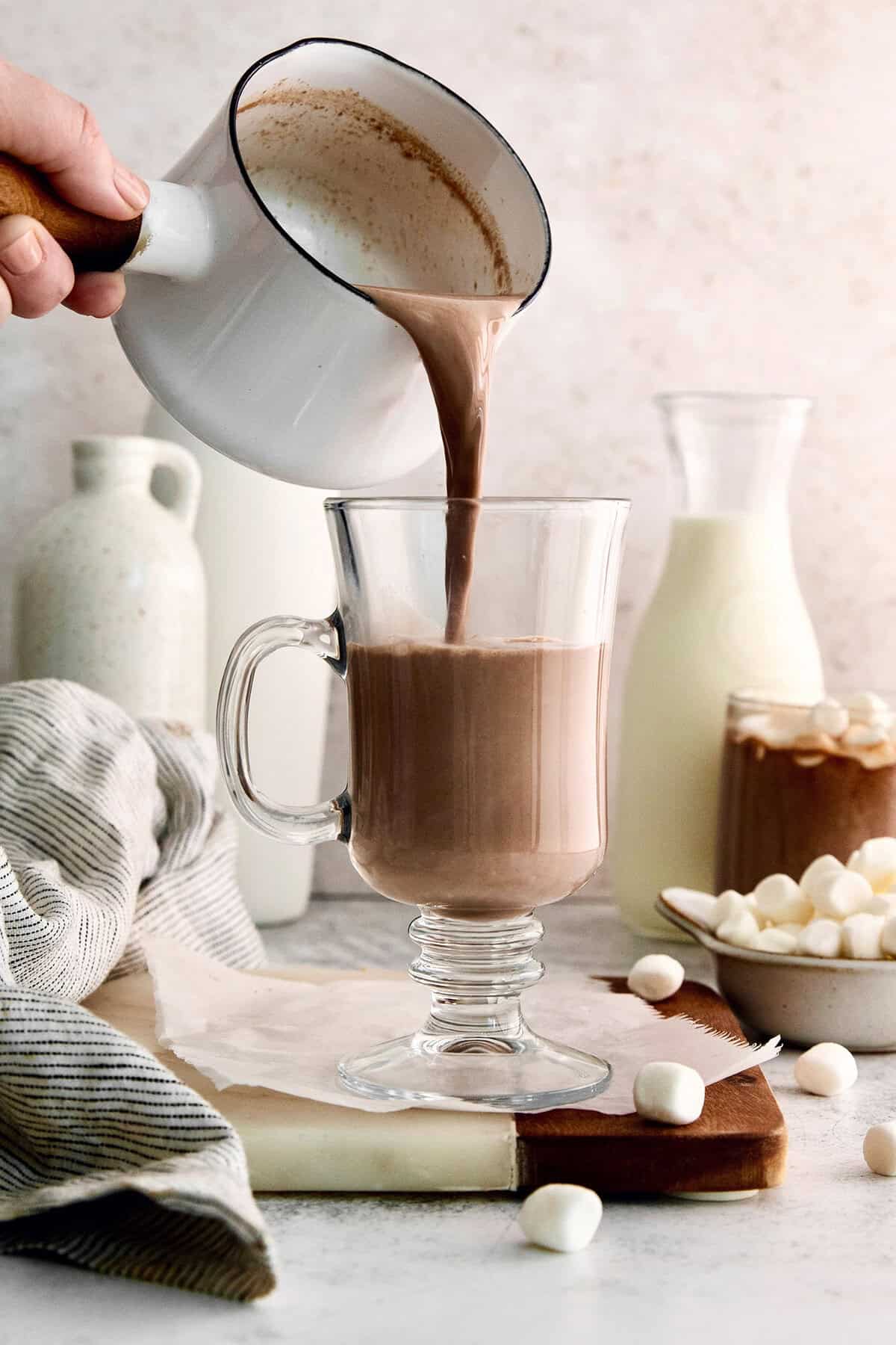 Pouring hot chocolate from pan into mug