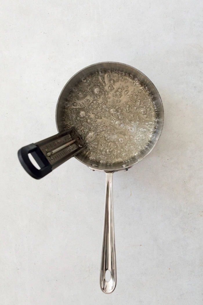 Syrup for marshmallows in pan with candy thermometer