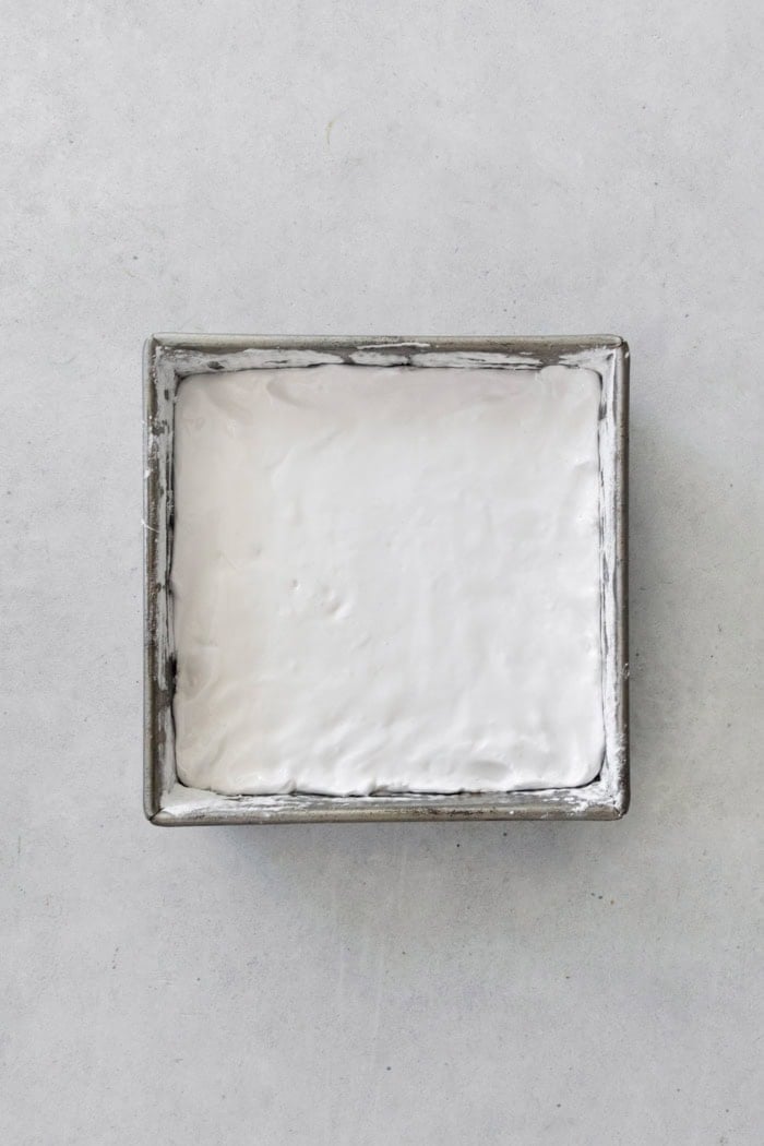 Overhead view of marshmallow mixture spread into square pan