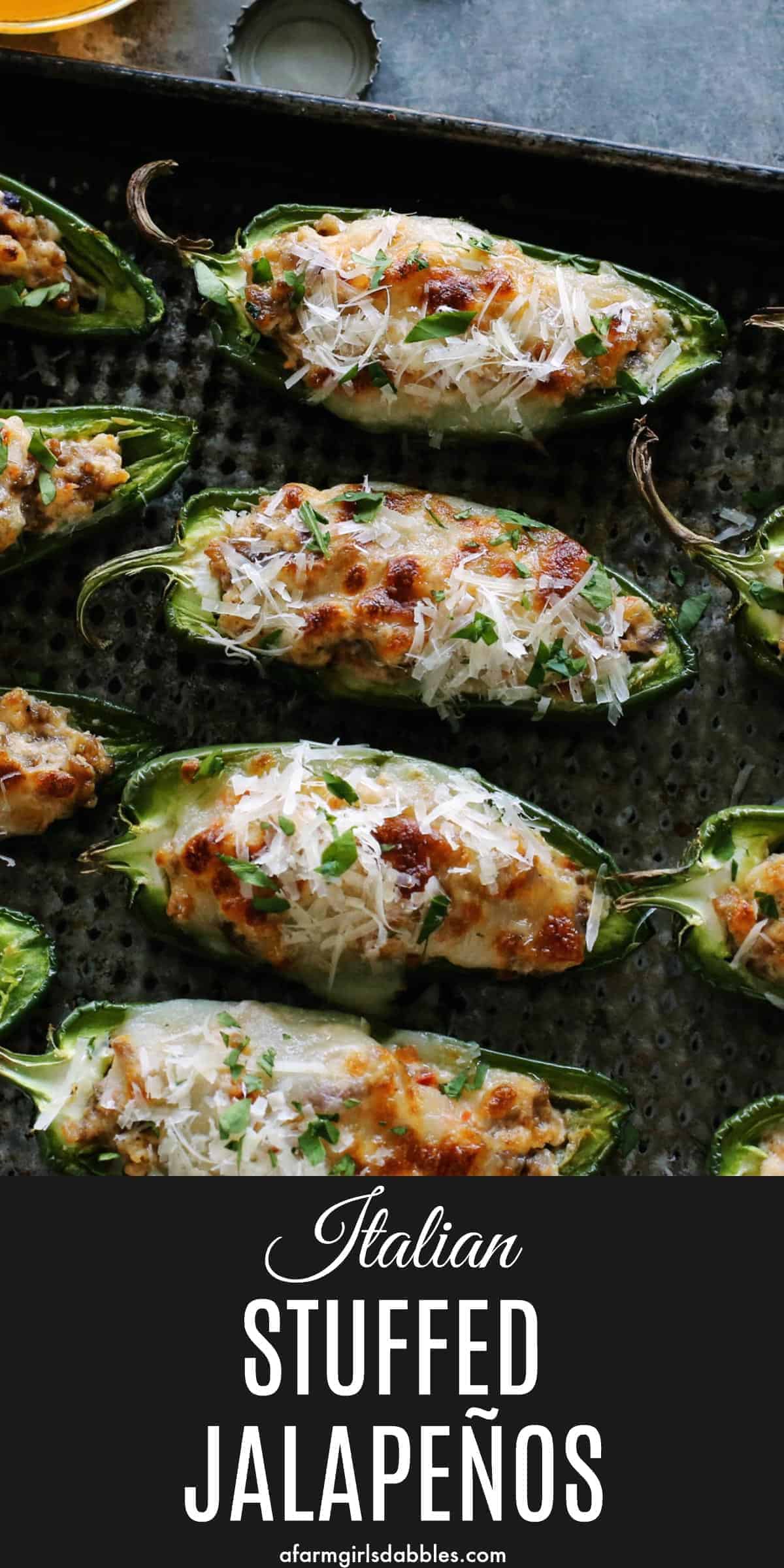 pinterest image of stuffed jalapeno peppers with sausage and cheese on a pan