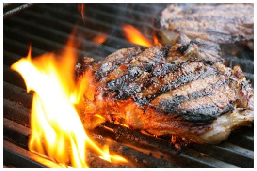 two steaks on a grill
