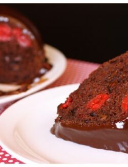 This slice of chocolate cherry cake is filled with cherries, chocolate, and topped with fudge.