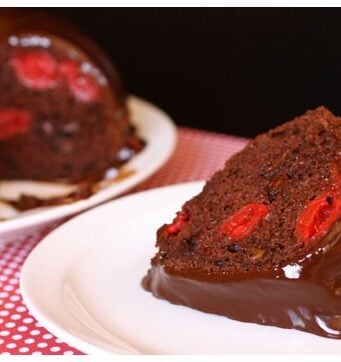 This slice of chocolate cherry cake is filled with cherries, chocolate, and topped with fudge.