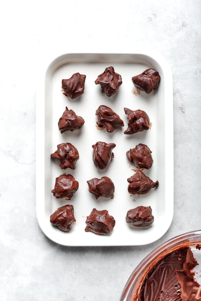 Overhead view of chocolate truffle mixture portioned on pan