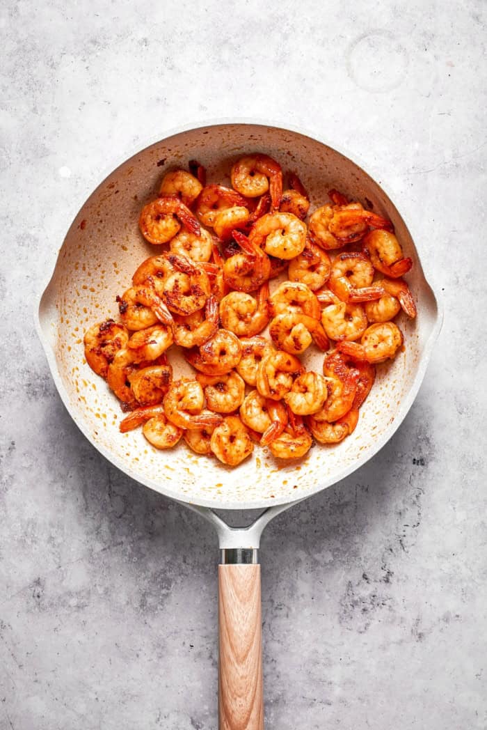 Shrimp cooking in skillet.