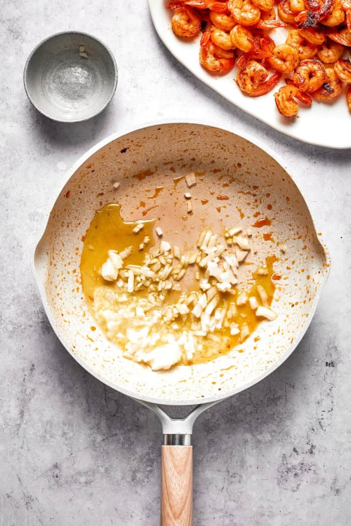 Onion added to skillet with butter and oil.