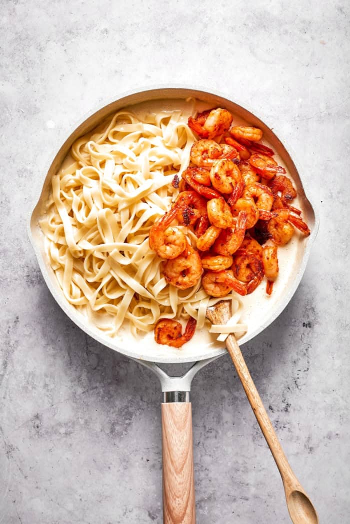 Shrimp and pasta added to cream sauce.