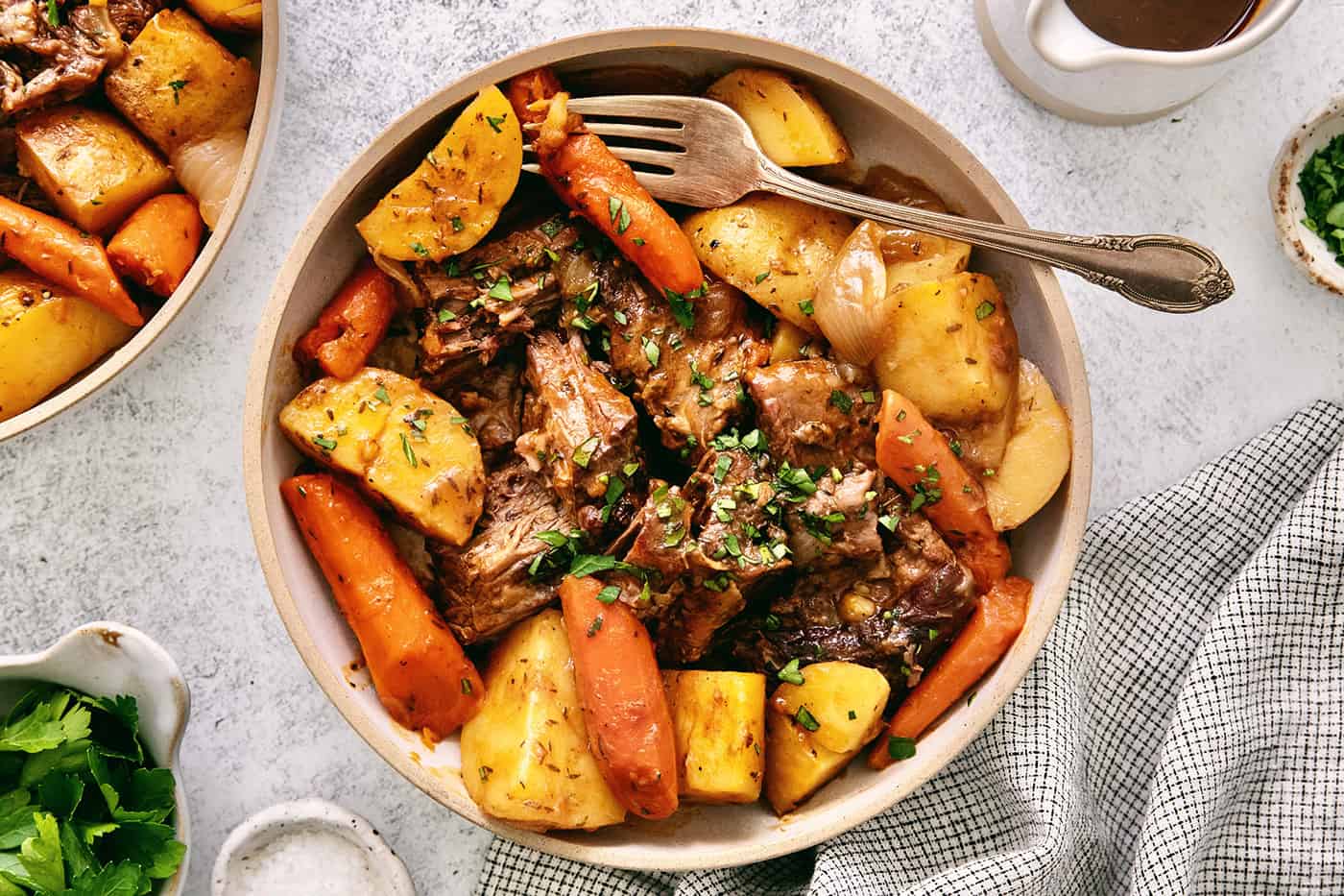 Overhead view of a bowl of pot roast with potatoes and carrots