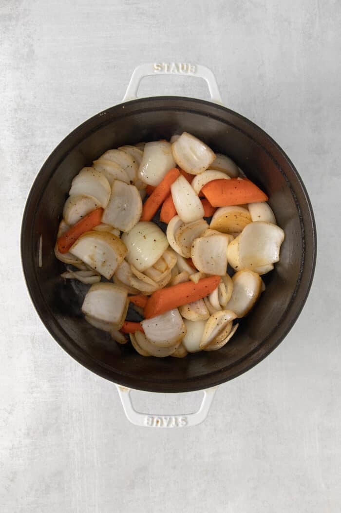 Carrots, onions, and potatoes in a pot