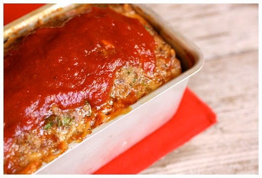 a pan of meatloaf topped with chili sauce