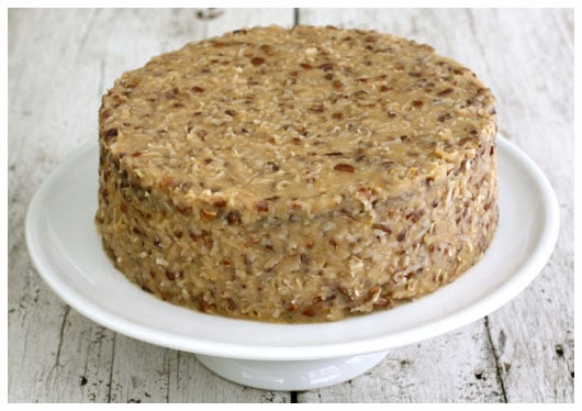 a whole german chocolate cake on a white stand