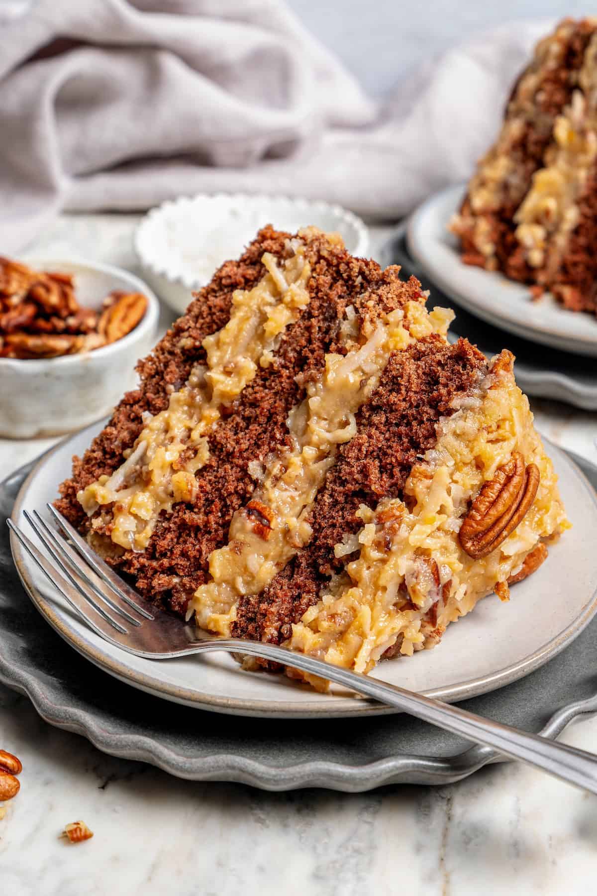 Slice of classic German chocolate cake on plate with fork