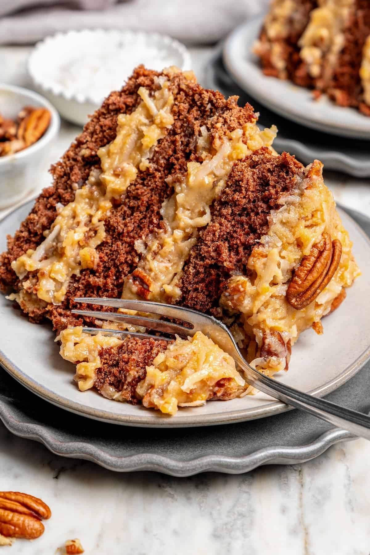 Fork digging into slice of German chocolate cake