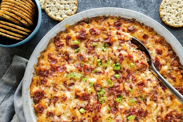 Reuben Dip baked in a metal pie plate, with crackers