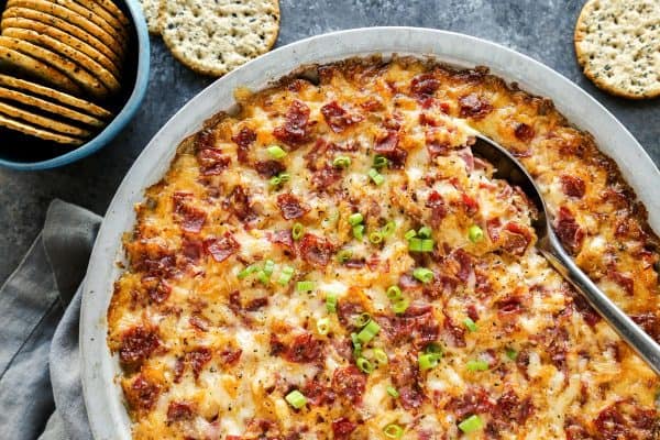 Reuben Dip baked in a metal pie plate, with crackers