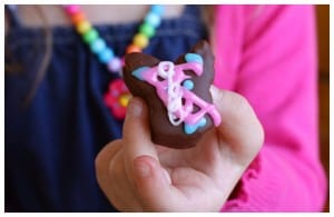 a girl holding a chocolate marshmallow bunny