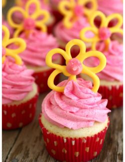 cupcakes with pink frosting and yellow candy flowers