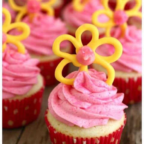 cupcakes with pink frosting and yellow candy flowers