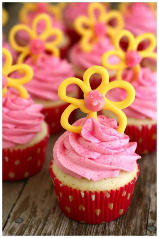 cupcakes with pink frosting and yellow candy flowers