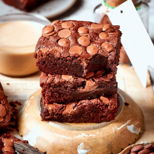 Stack of 3 fudgy brownies on overturned plate