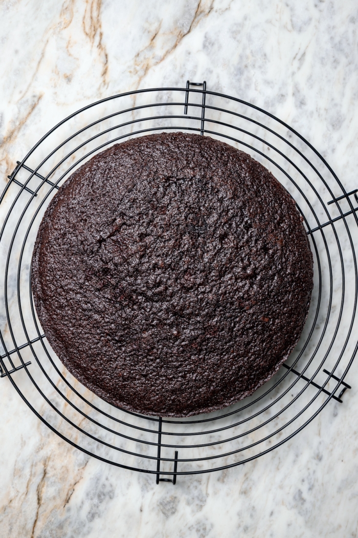 Chocolate cake layer on wire rack.