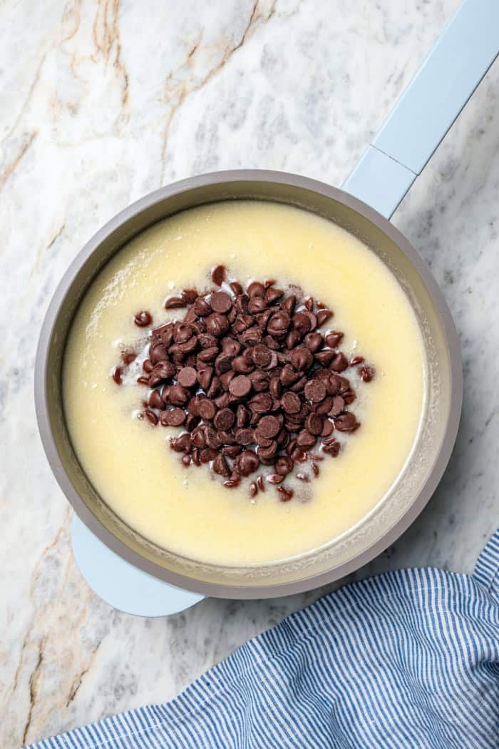 Chocolate chips added to liquid ingredients for frosting.