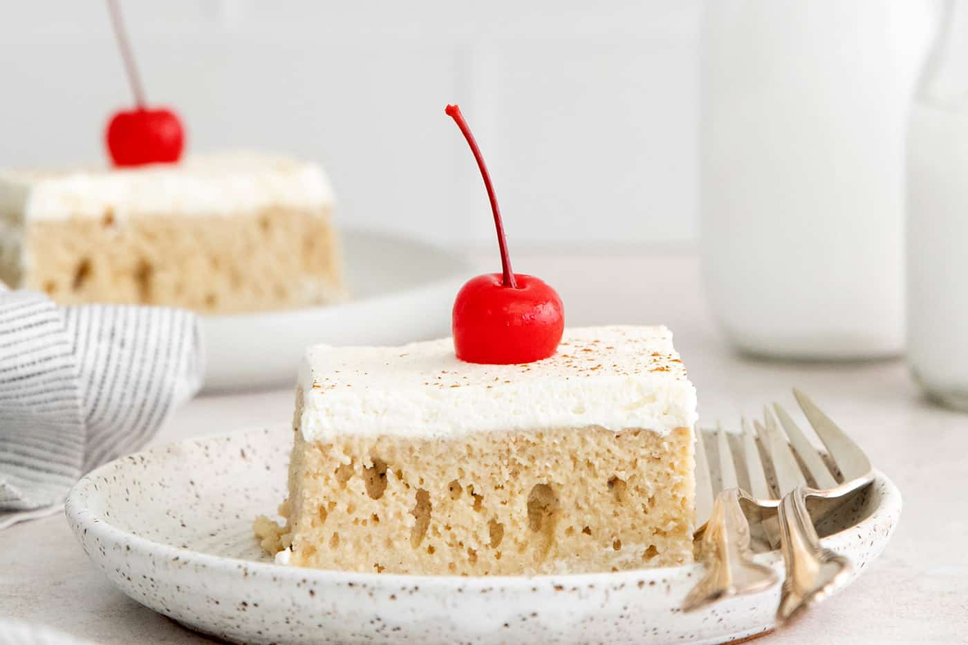 A slices of tres leches cake on a white plate