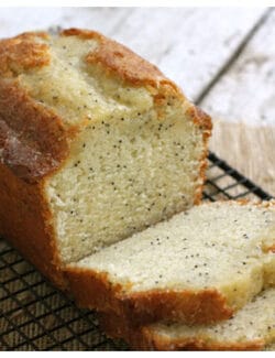 Poppyseed bread sliced up and sitting on a wire rack