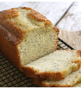 Poppyseed bread sliced up and sitting on a wire rack