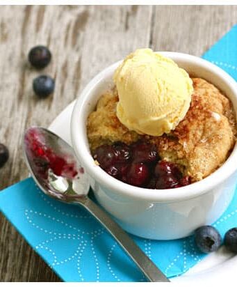 These pot pies are filled with fresh blueberries and topped with ice cream.