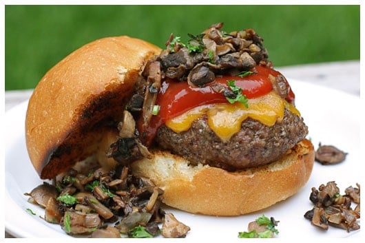 a cheeseburger slider with ketchup and mushrooms