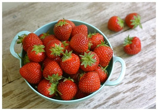 a colander of strawberries