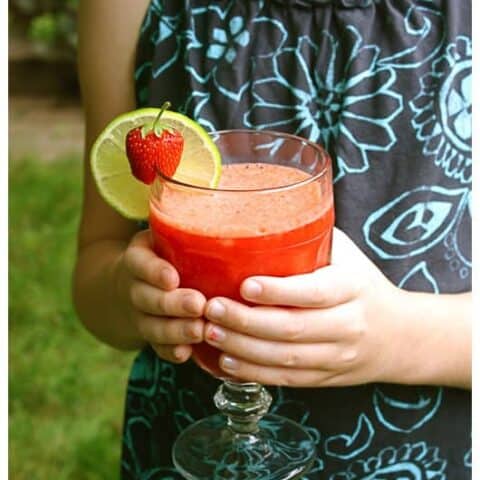 a girl holding a strawberry beverage